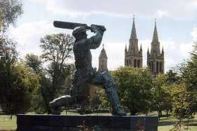 Sir Donald Bradman drives through the covers, under the watch of St Peter's Cathedral, Adelaide