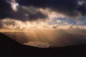 The sun bursts through the cloud onto Derwent Water