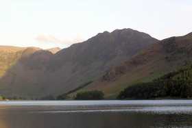 The distinctive shape of Wainwright's favourite fell, Hay Stacks, in the evening sun above Buttermere