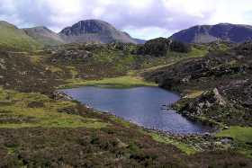 Blackbeck Tarn, with Great Gable rising up in the distance Blackbeck Tarn, with Great Gable rising up in the distance