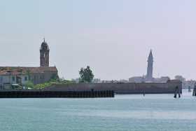 The church towers of Santa Caterina on Mazzorbo and precarious San Martino on Burano The church towers of Santa Caterina on Mazzorbo and precarious San Martino on Burano