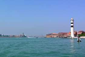 A view of Murano and its lighthouse, with Isola di San Michele and Venice on the horizon A view of Murano and its lighthouse, with Isola di San Michele and Venice on the horizon