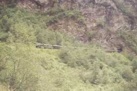 The Fl&sring;m train looks like a toy compared to the mountains it passes by The Fl&sring;m train looks like a toy compared to the mountains it passes by